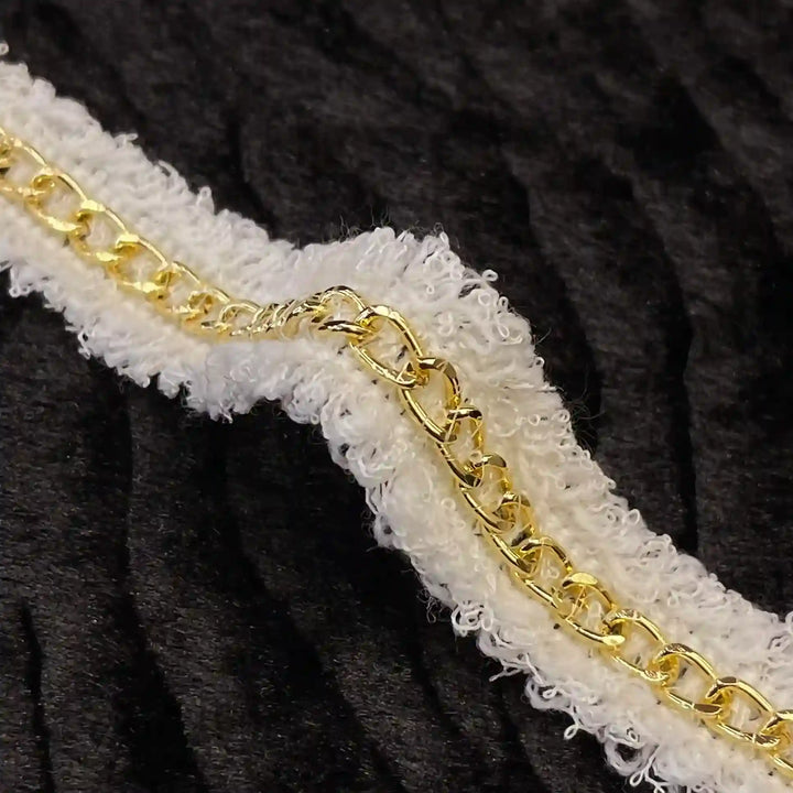 ANI Accessories close-up of gold curb chain on white tweed trim 