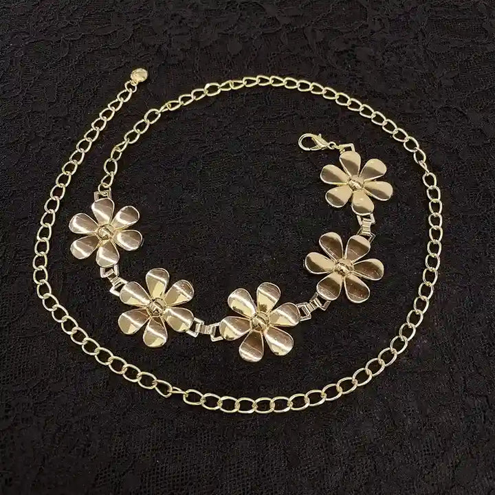 ANI Accessories gold daisy chain belt laid flat on black fabric 