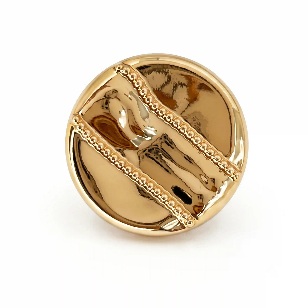 ANI Accessories polished gold round metal button with two raised diagonal beaded stripes, angled front view with white color background 