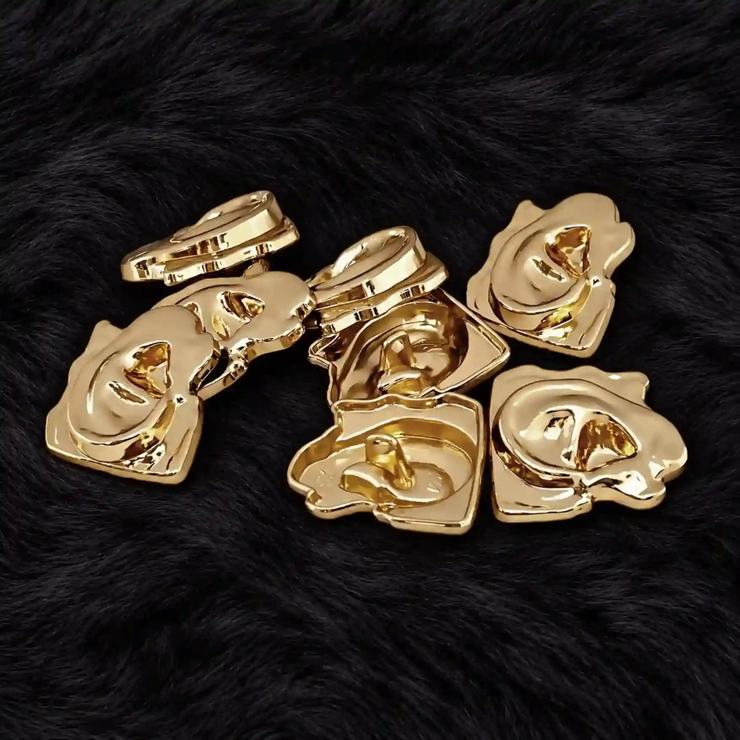 ANI Accessories gold ear design buttons on black fur with white color background 