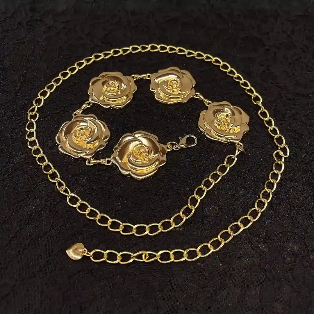 ANI Accessories gold flower chain belt laid in a circle on black fabric 