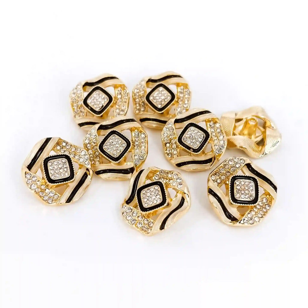 ANI Accessories set of 8 gold geometric rhinestone metal buttons with black enamel accents scattered on white