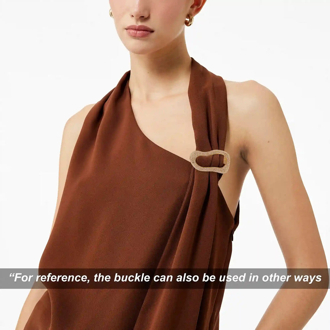 ANI Accessories gold rhinestone freeform buckle on the halter neckline of a rust brown top Background 