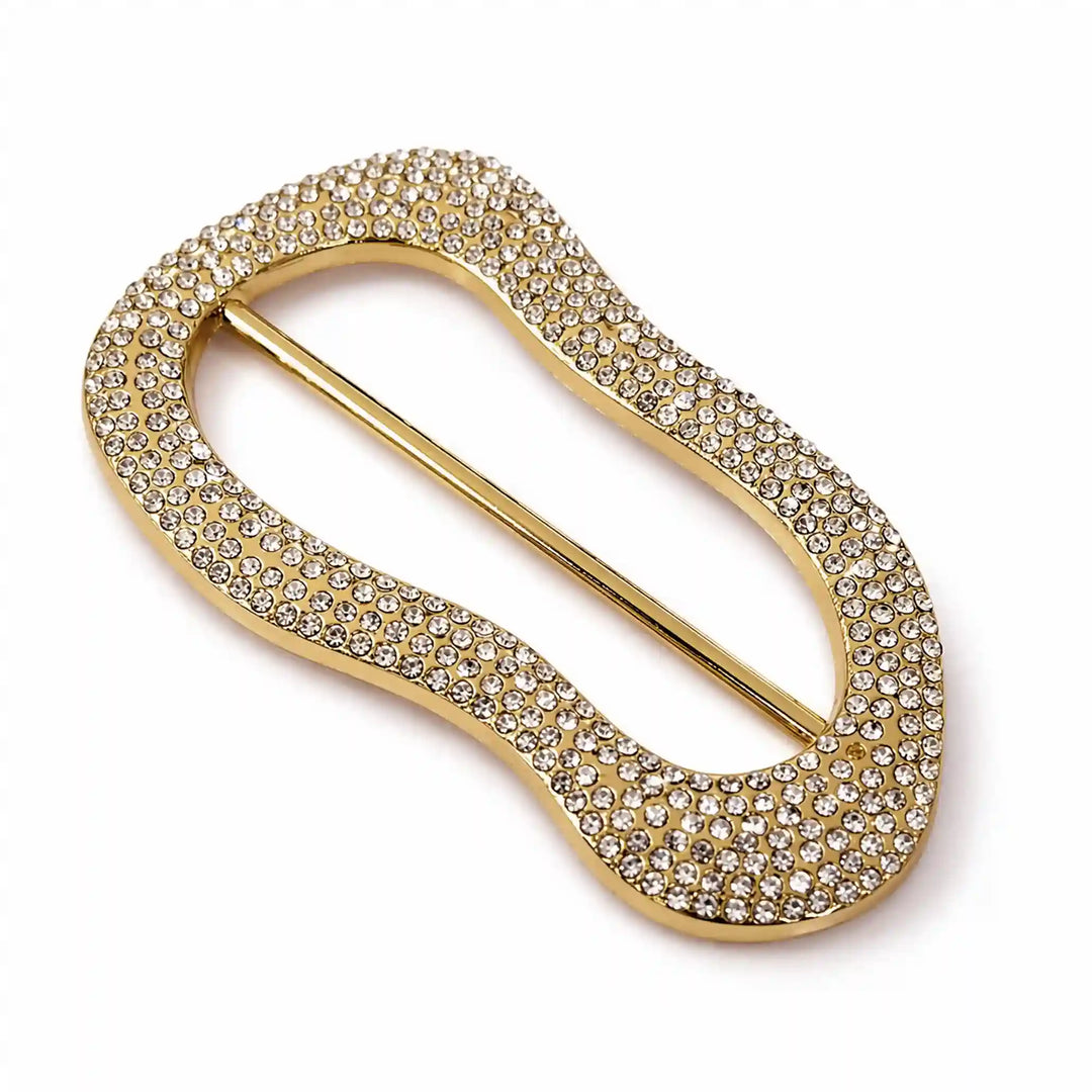 ANI Accessories angled view of gold rhinestone pavé freeform slide buckle with centre bar