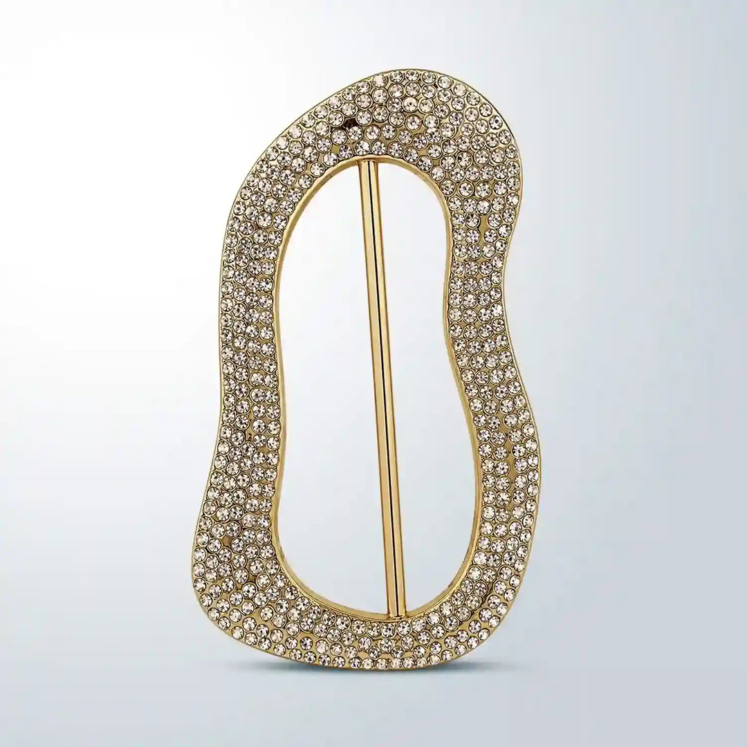 ANI Accessories gold freeform slide buckle covered in clear pavé rhinestones, front view on grey background 