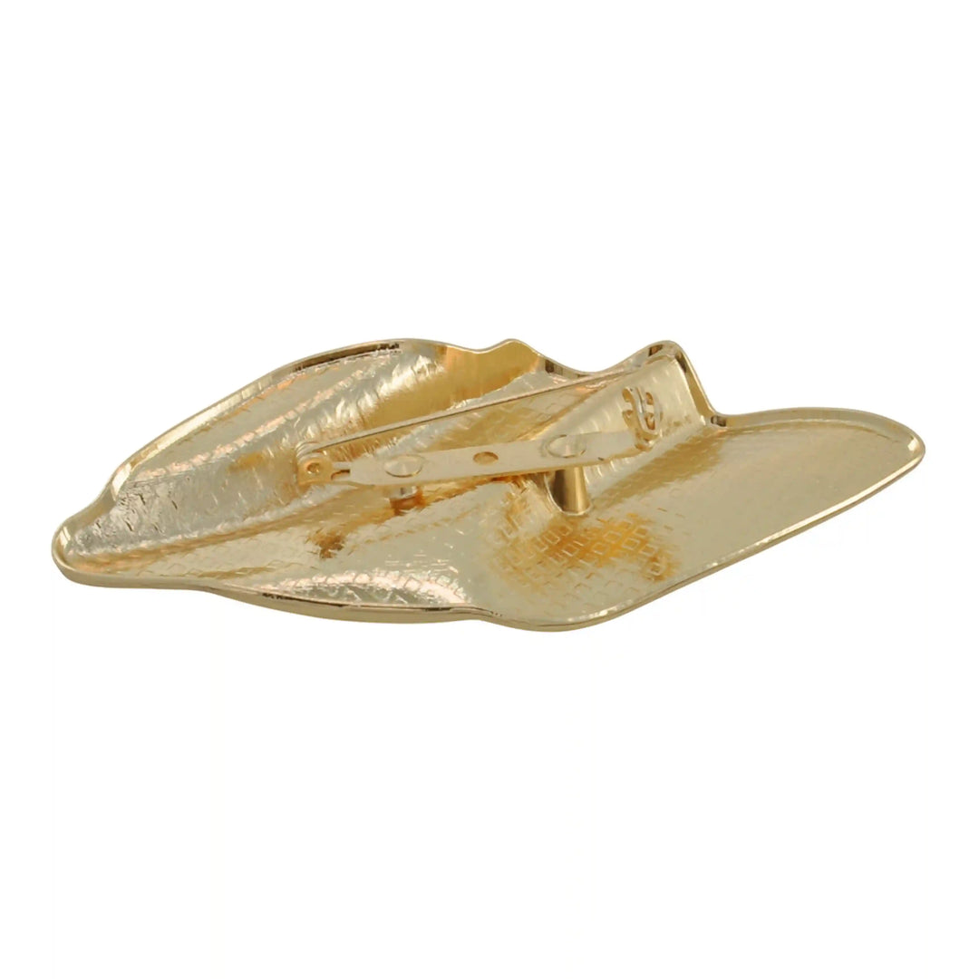 Side view of the gold sculptural brooch showing the folds and creases with white  color background 
