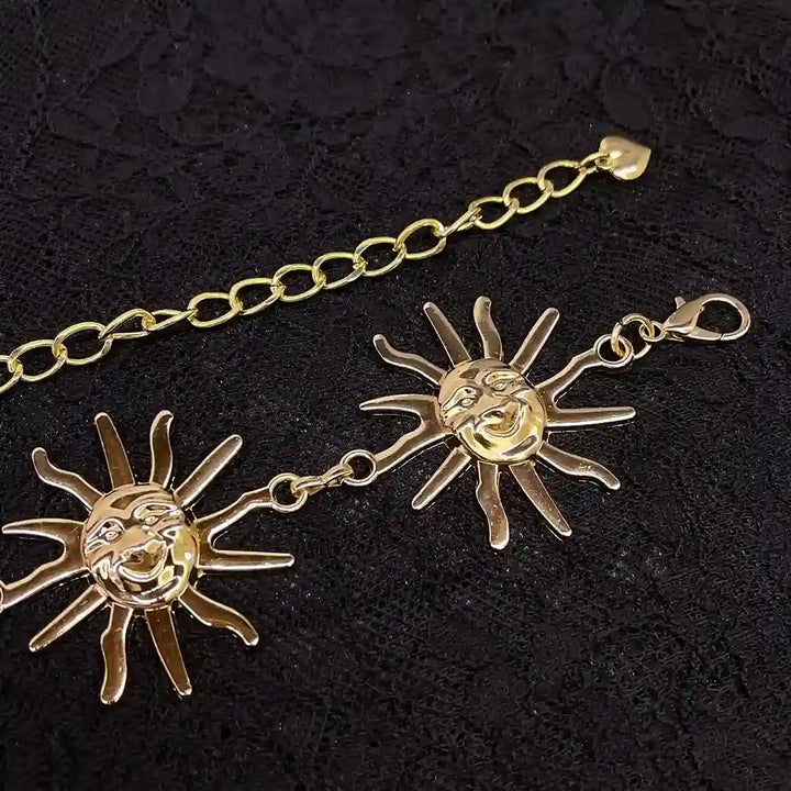 ANI Accessories close-up of a gold sun face with rays and lobster clasp 