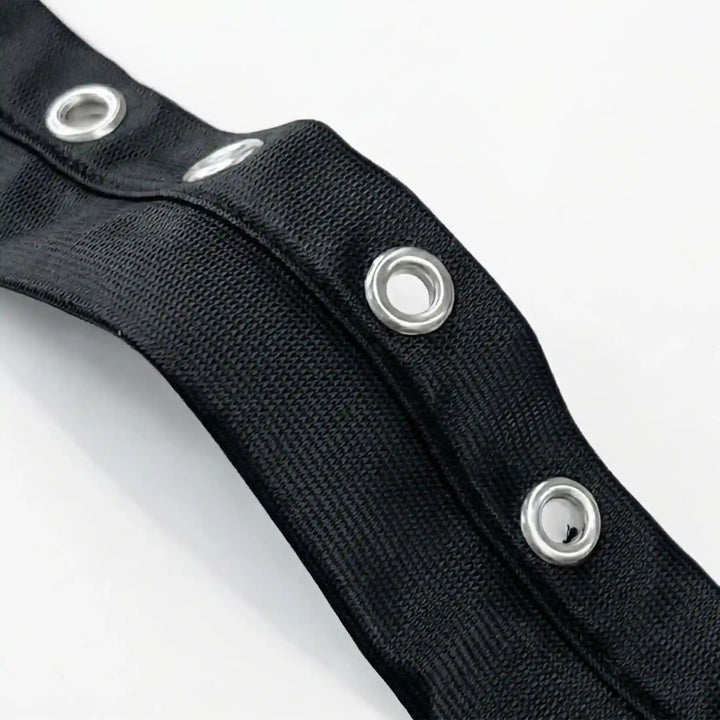ANI Accessories close-up of open metal eyelets on black grommet tape for clothes with white color background 