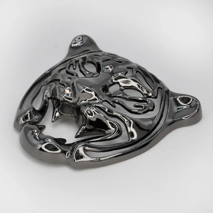 Side view of the gunmetal tiger face emblem showing the laser-cut stripes with white color background 