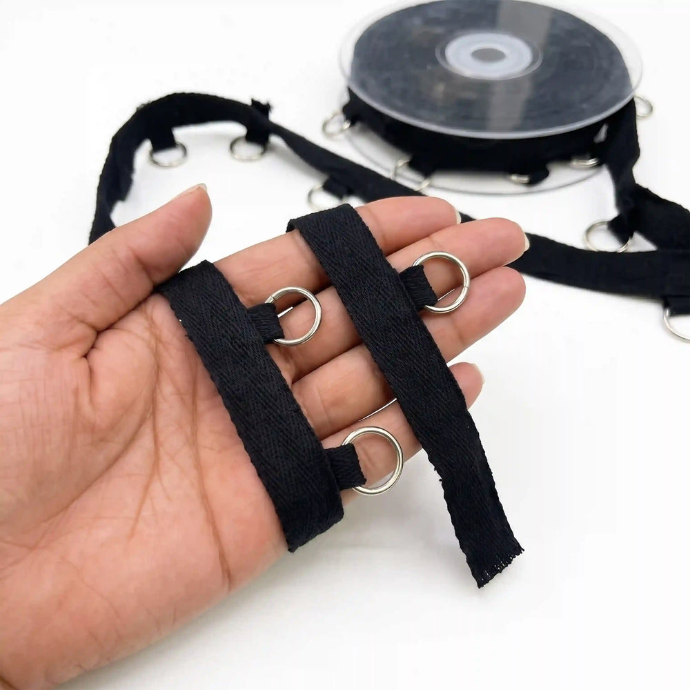ANI Accessories hanging ring trim held in hand next to the roll with white color background 