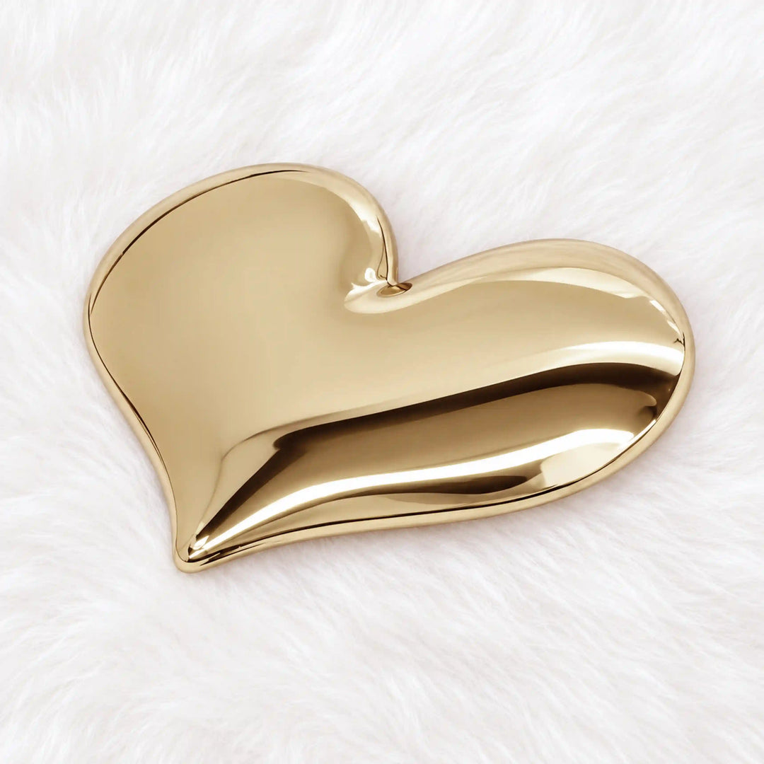 ANI Accessories large gold heart button on white fur, angle view with white color fur background 