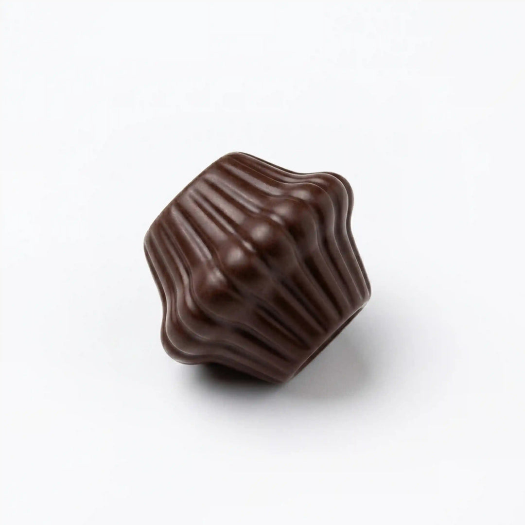 ANI Accessories mini dark brown fluted cord end bead lying on its side, close-up of the vertical ridges and polished finish 
with white Background 