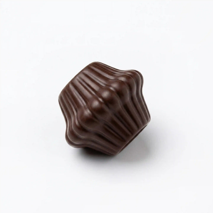 ANI Accessories mini dark brown fluted cord end bead lying on its side, close-up of the vertical ridges and polished finish 
with white Background 