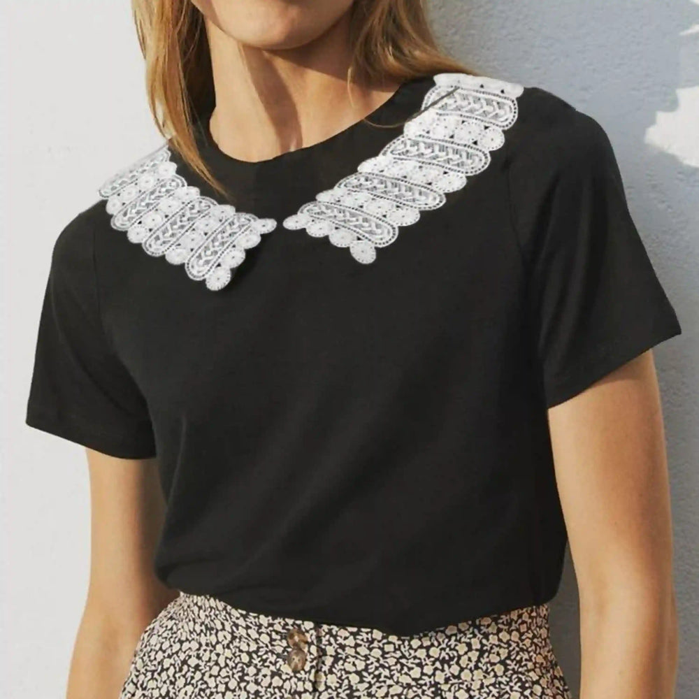 Woman wearing a black t-shirt with a white round collar made from motif strips 