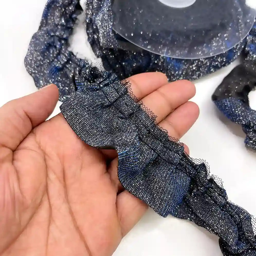 ANI Accessories navy blue glitter frill lace held in hand next to the roll 