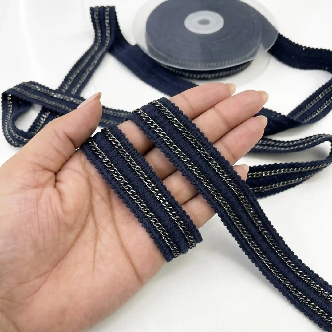ANI Accessories navy blue lace border with metal chain held in hand next to the roll with white color background 