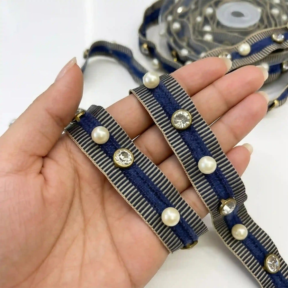 ANI Accessories navy blue pearl lace for suit held in hand with white color Background