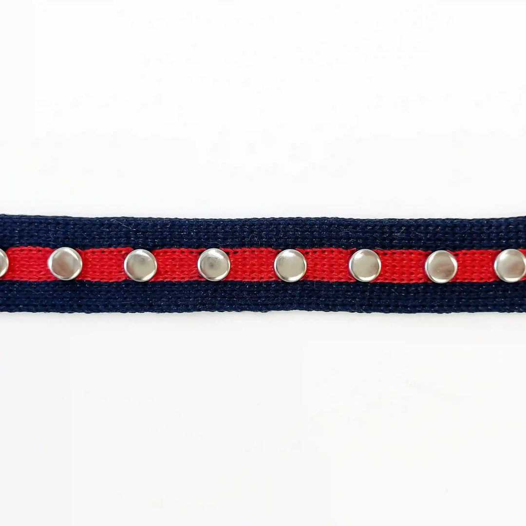 ANI Accessories navy blue tape with red stripe and silver studs laid flat with white color background 