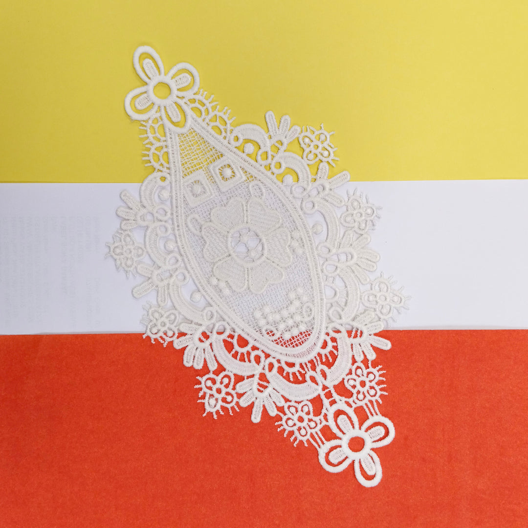 ANI Accessories off-white medallion applique patch on a yellow, white and orange background 