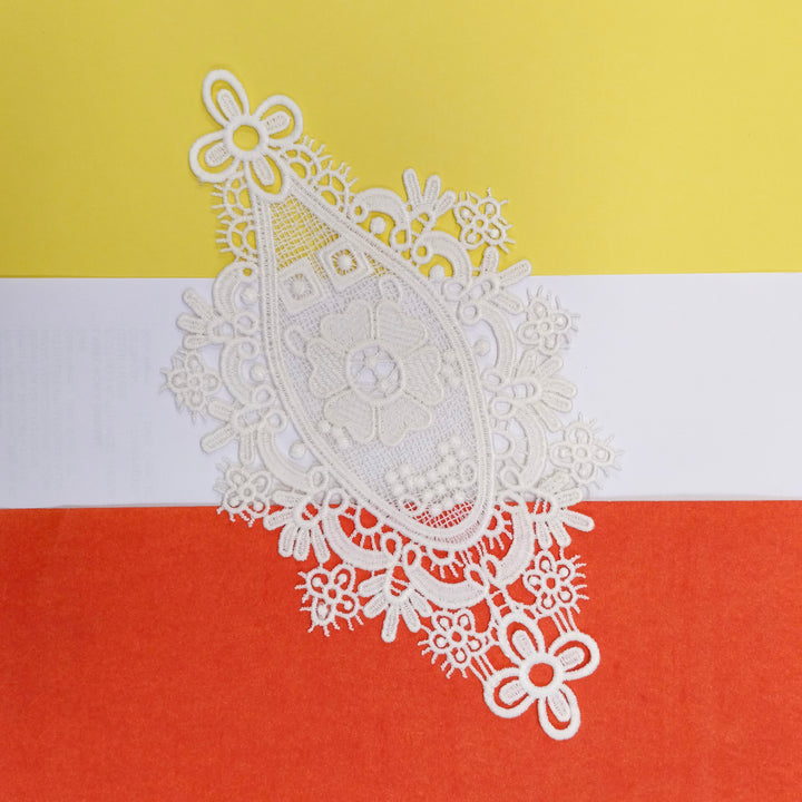 ANI Accessories off-white medallion applique patch on a yellow, white and orange background 