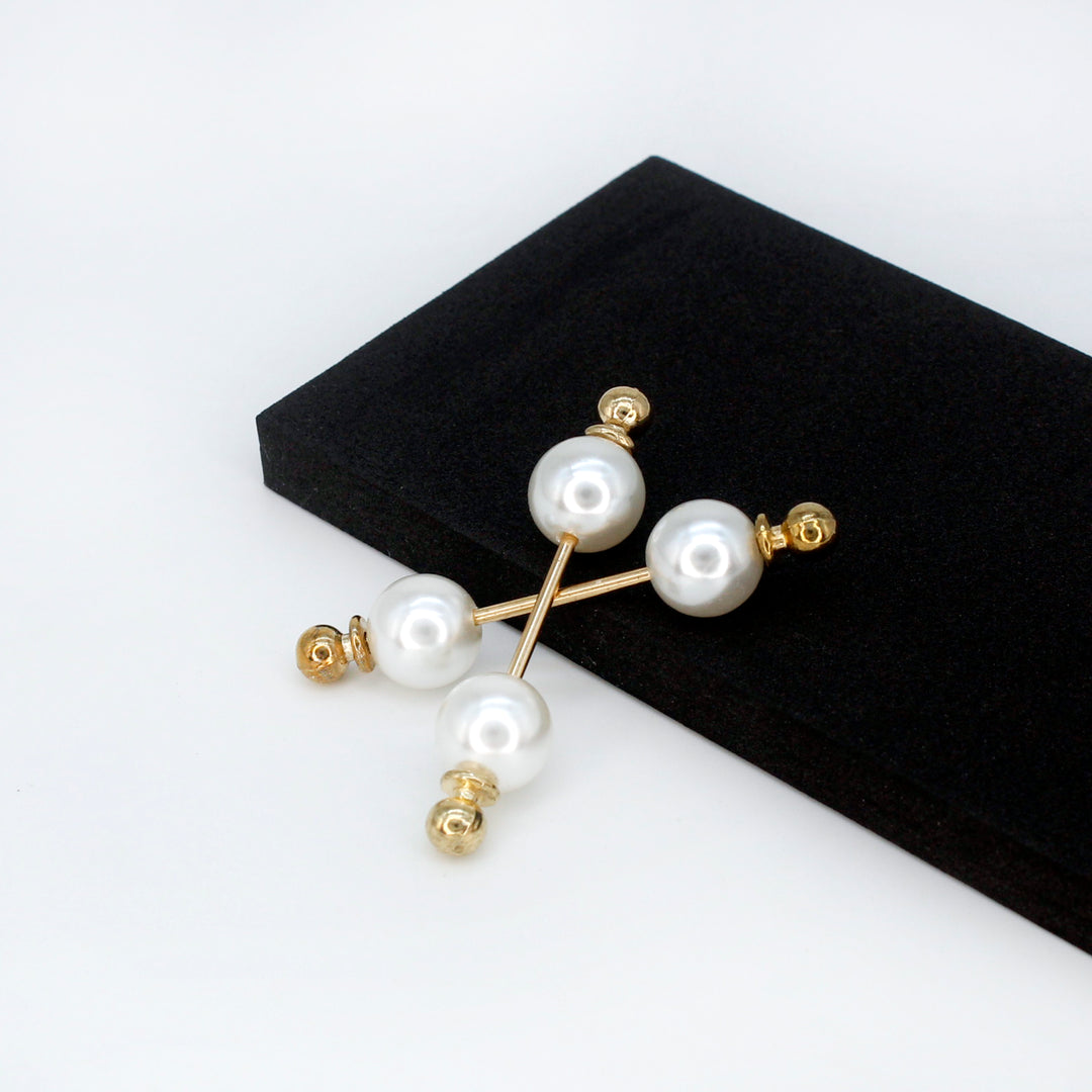 Elegant Pearl Bar Brooches for Women with Gold Accents on a Black Display