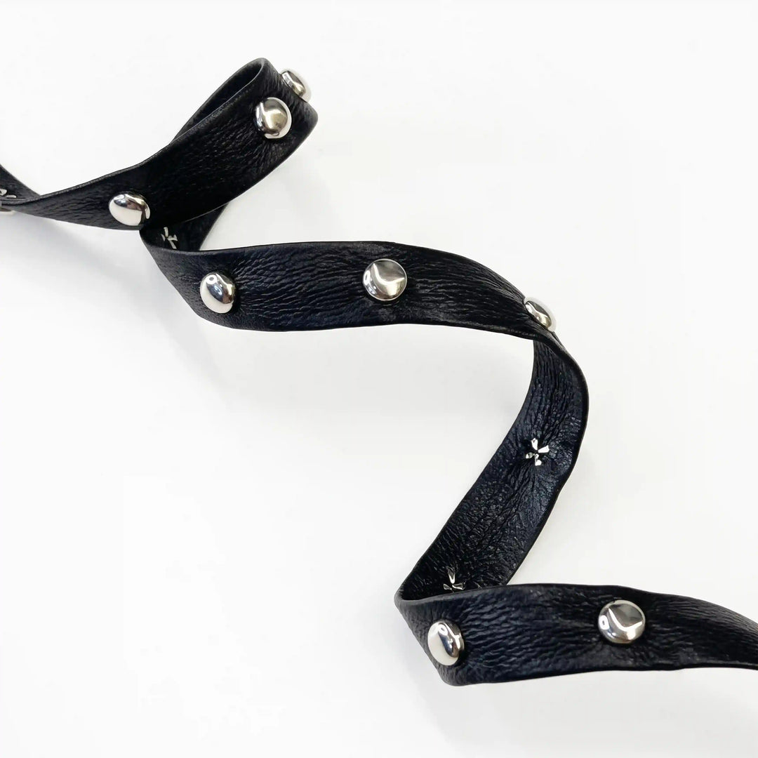 ANI Accessories close-up of pebbled faux leather with domed silver studs with white color background 