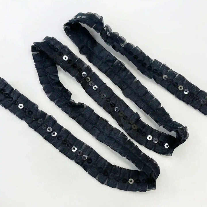 ANI Accessories pleated lace trim with black and silver sequins in loose loops with white color background 