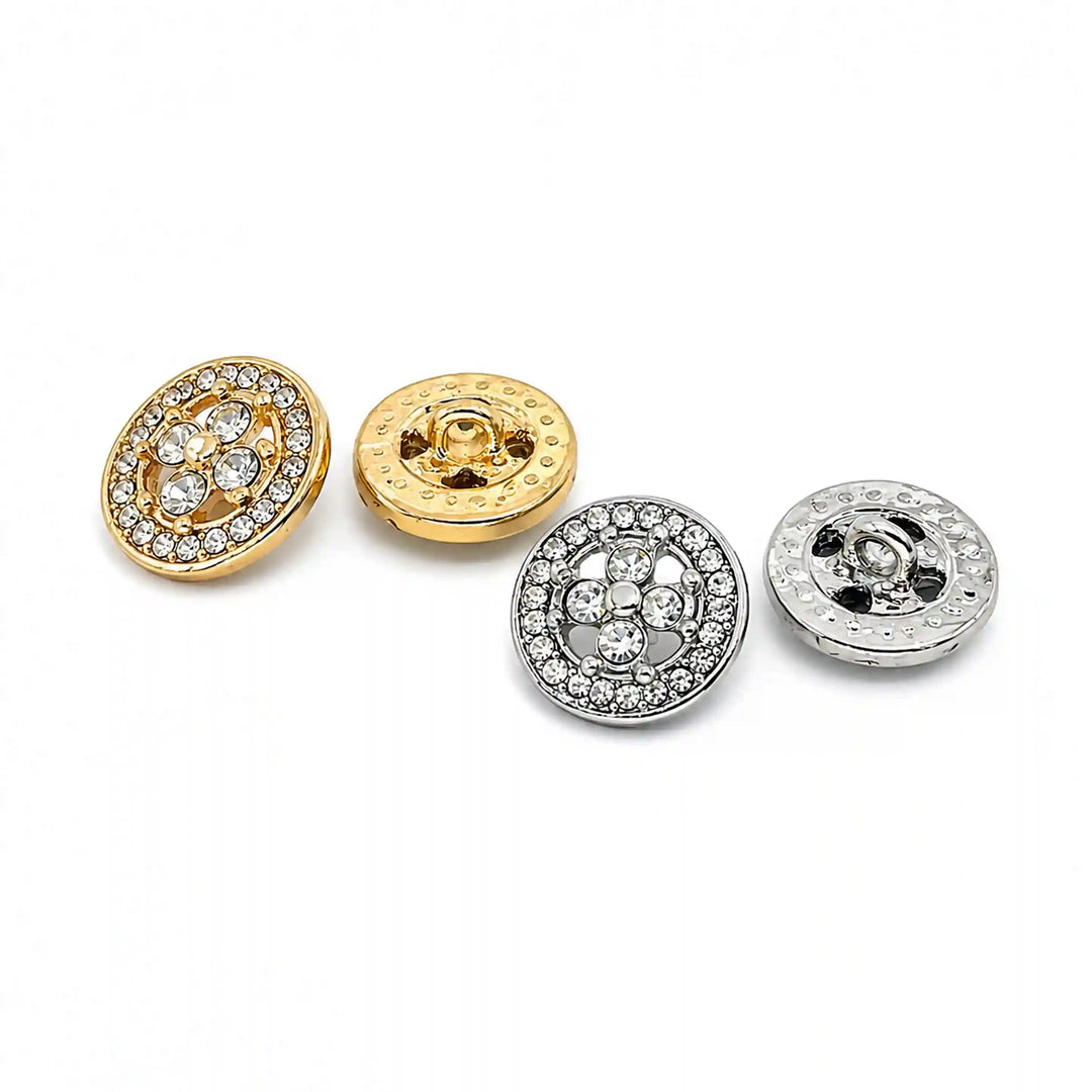 ANI Accessories gold and silver quatrefoil rhinestone metal buttons lined up, low angle view on white background 