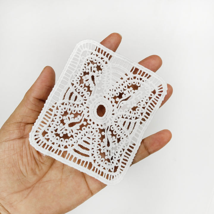ANI Accessories rectangle lace patch held in an open palm to show its size