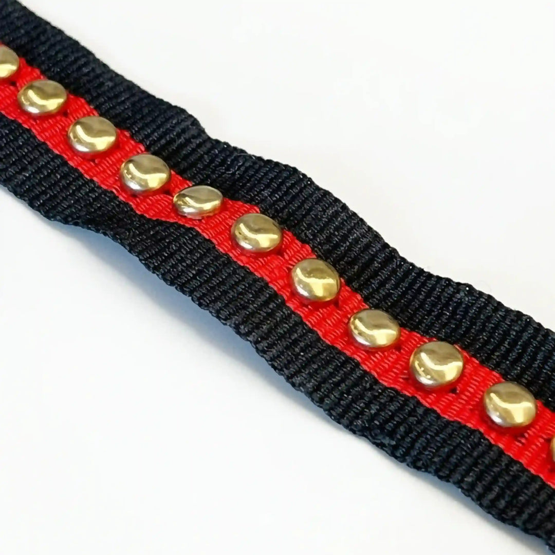 ANI Accessories red and black lace border with gold studs, folded in a zigzag with white color background 