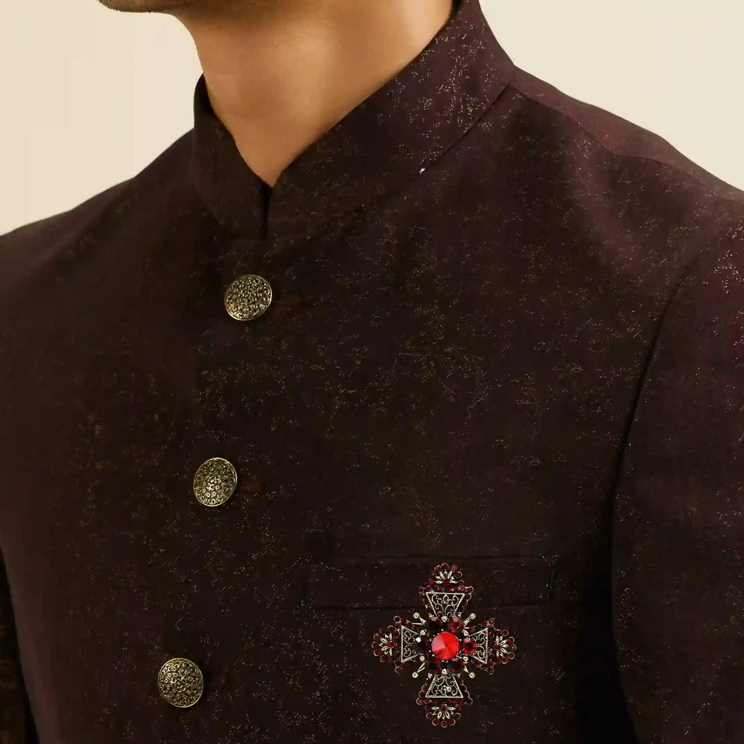 ANI Accessories red crystal cross brooch pinned on a maroon jodhpuri suit 