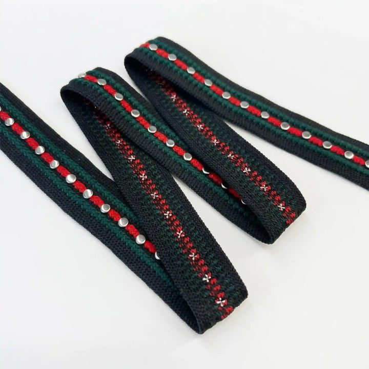 ANI Accessories red and green lace border with silver studs laid flat on white with white color background 