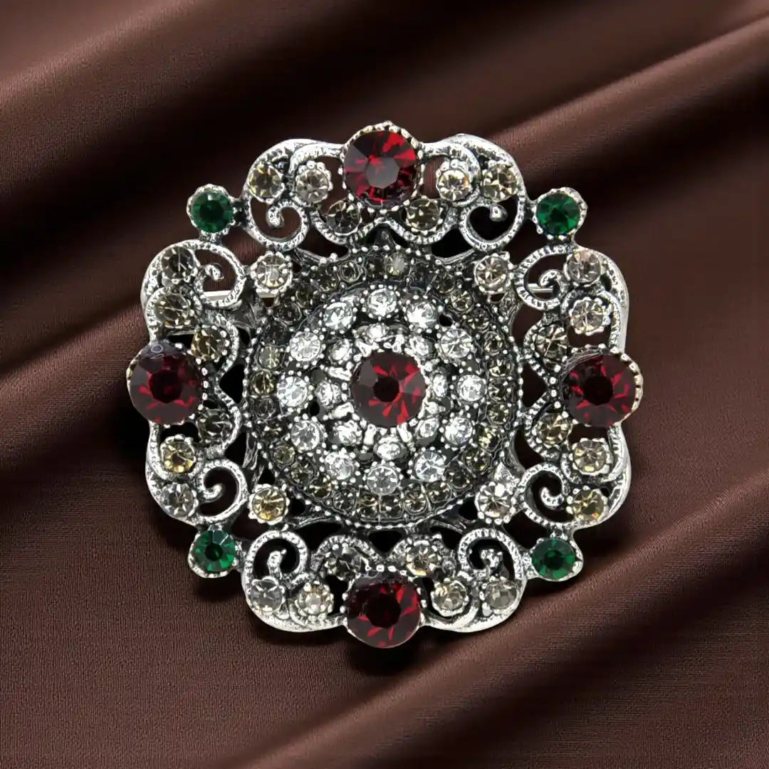 ANI Accessories red stone rhinestone brooch in antique silver on brown satin 