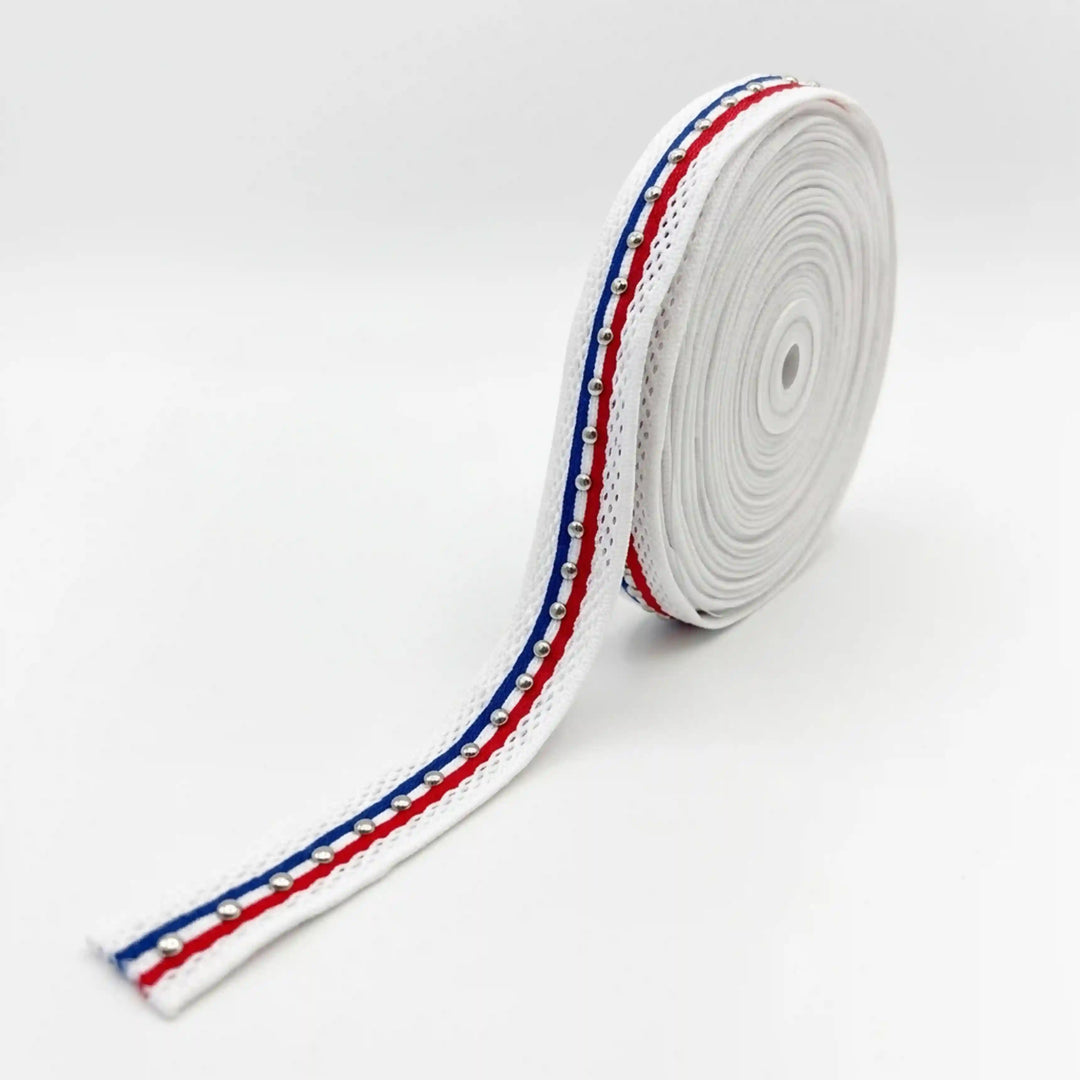 ANI Accessories close-up of red, white and blue ribbon trim with silver metal studs with white color background 