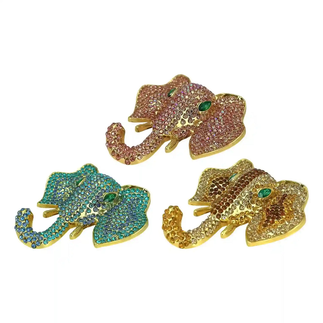 ANI Accessories rhinestone elephant brooch in light pink, green and gold crystals, on white with white color background 