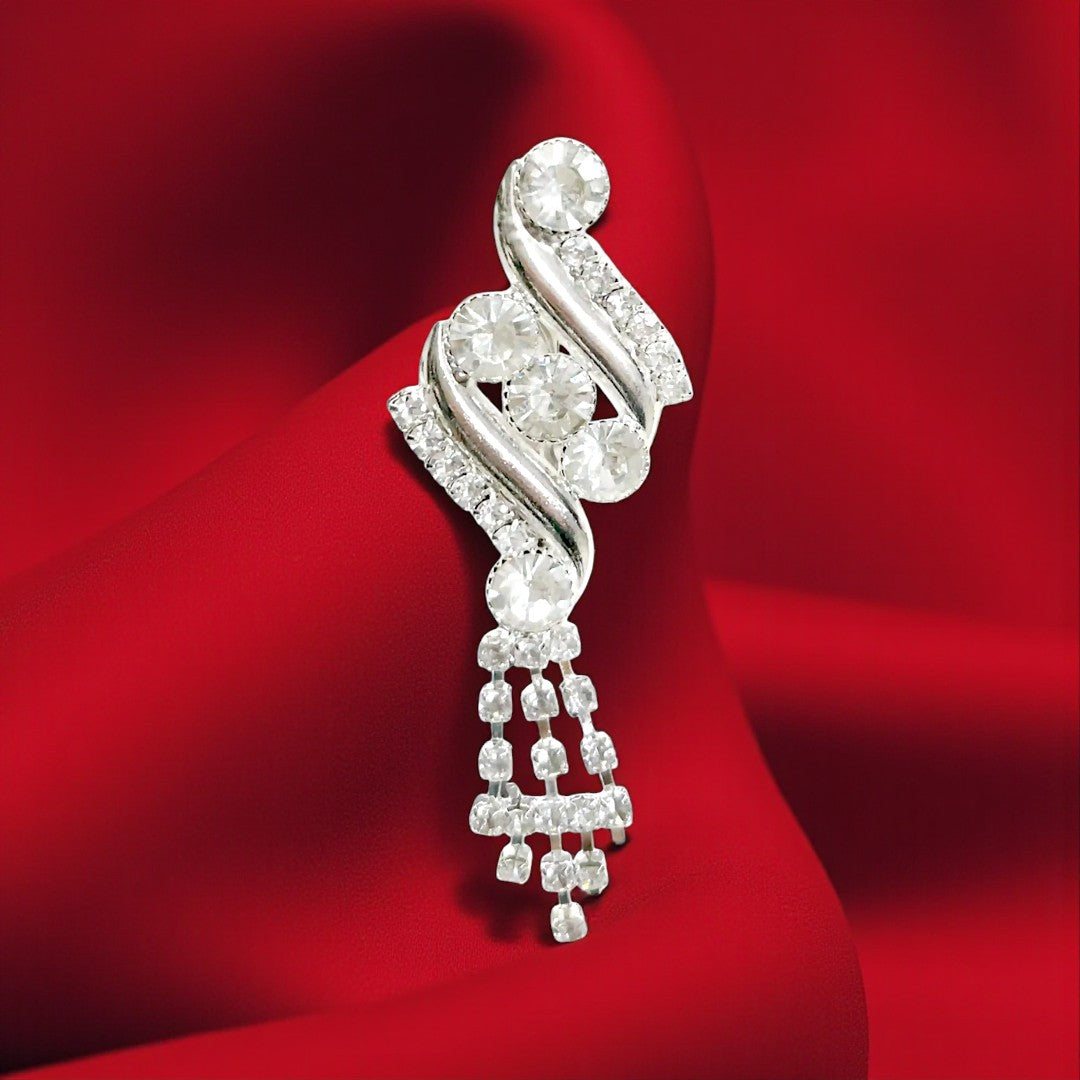 ANI Accessories rhinestone swirl brooch in silver with crystal tassels on red satin background 
