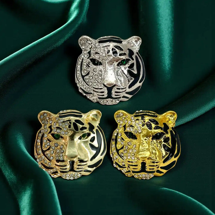 Rhinestone tiger brooch in silver, gold and shiny gold on green satin 