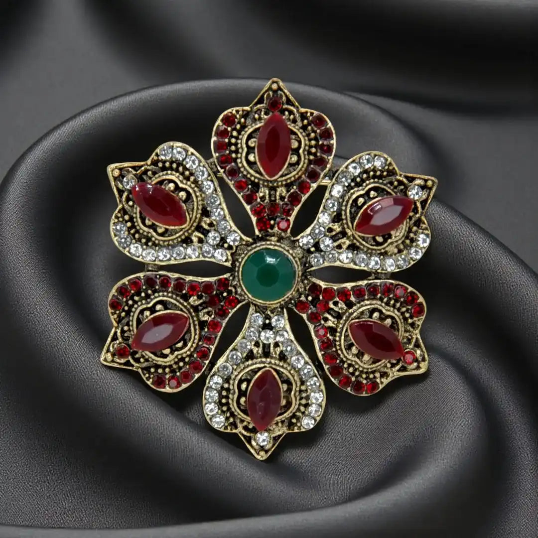 ANI Accessories ruby stone corsage brooch with red and clear rhinestones on dark grey satin