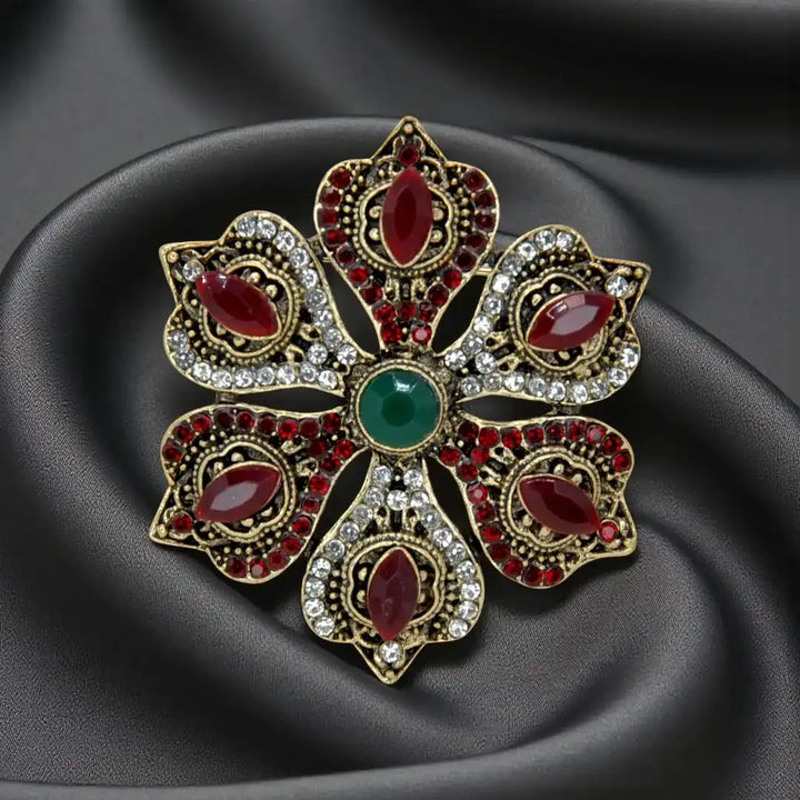 ANI Accessories ruby stone corsage brooch with red and clear rhinestones on dark grey satin