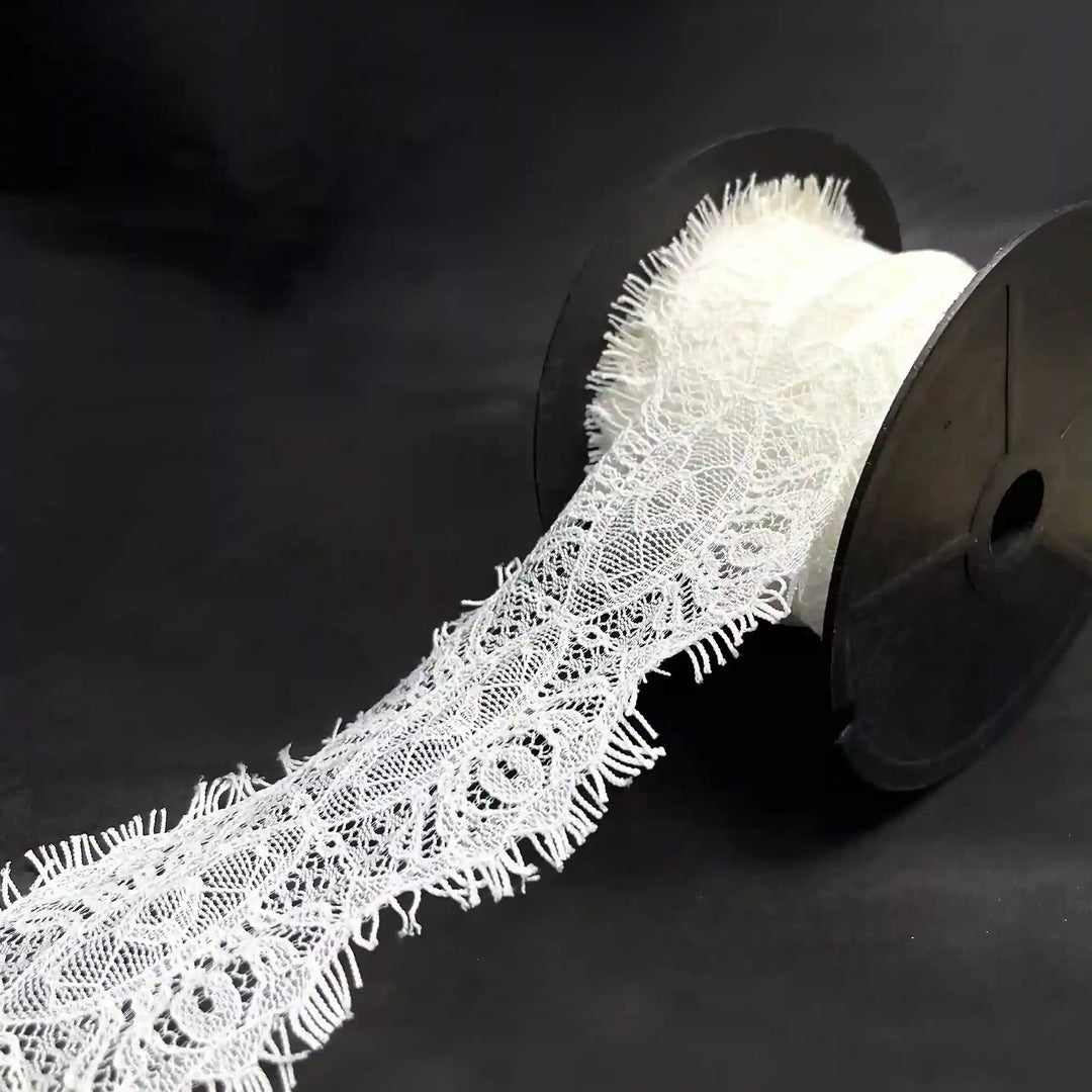 A roll of Scalloped Edge Eyelash Lace in white, perfect for crafting and decoration projects.