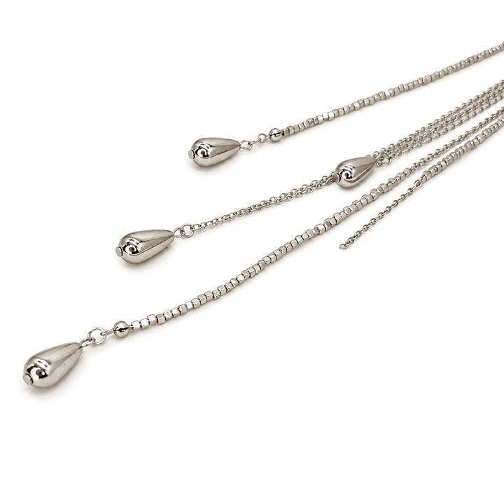 ANI Accessories silver chain tassel brooch close-up showing the teardrop drops at the chain ends with white color background 