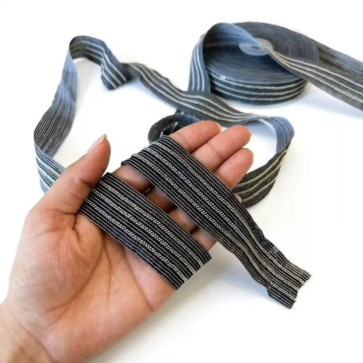 ANI Accessories silver lace for blouse sleeves held in hand to show the beads with white color background 