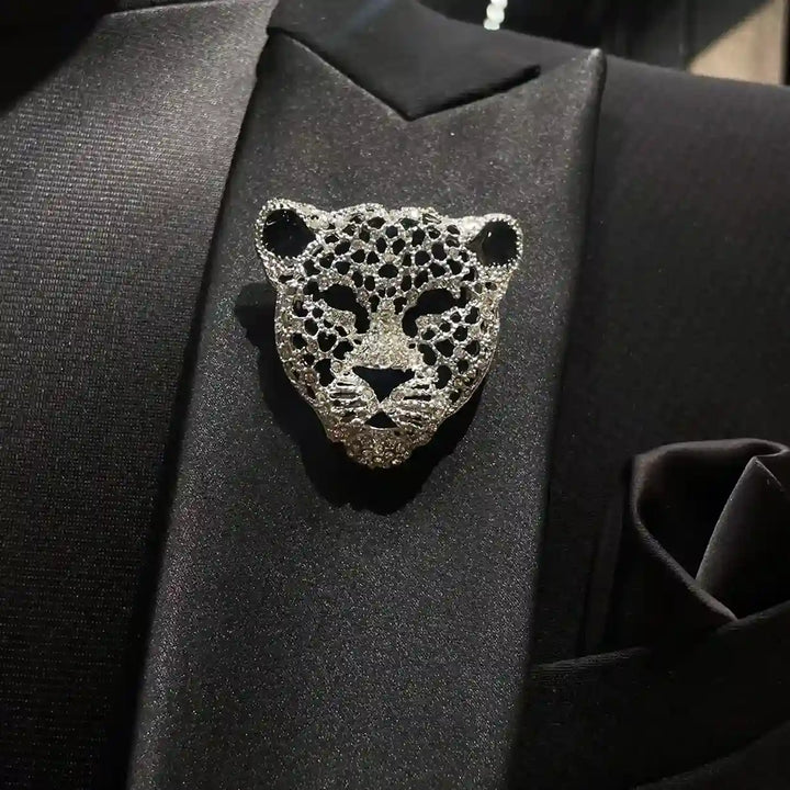 ANI Accessories silver leopard brooch pinned on the lapel of a black suit 
