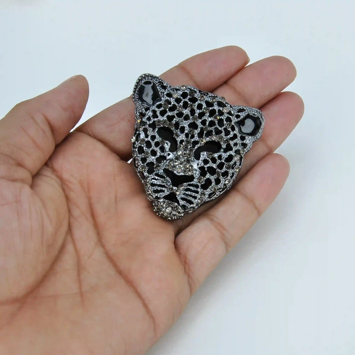 ANI Accessories silver leopard lapel pin held in hand to show its 4.8 cm size with white color background 