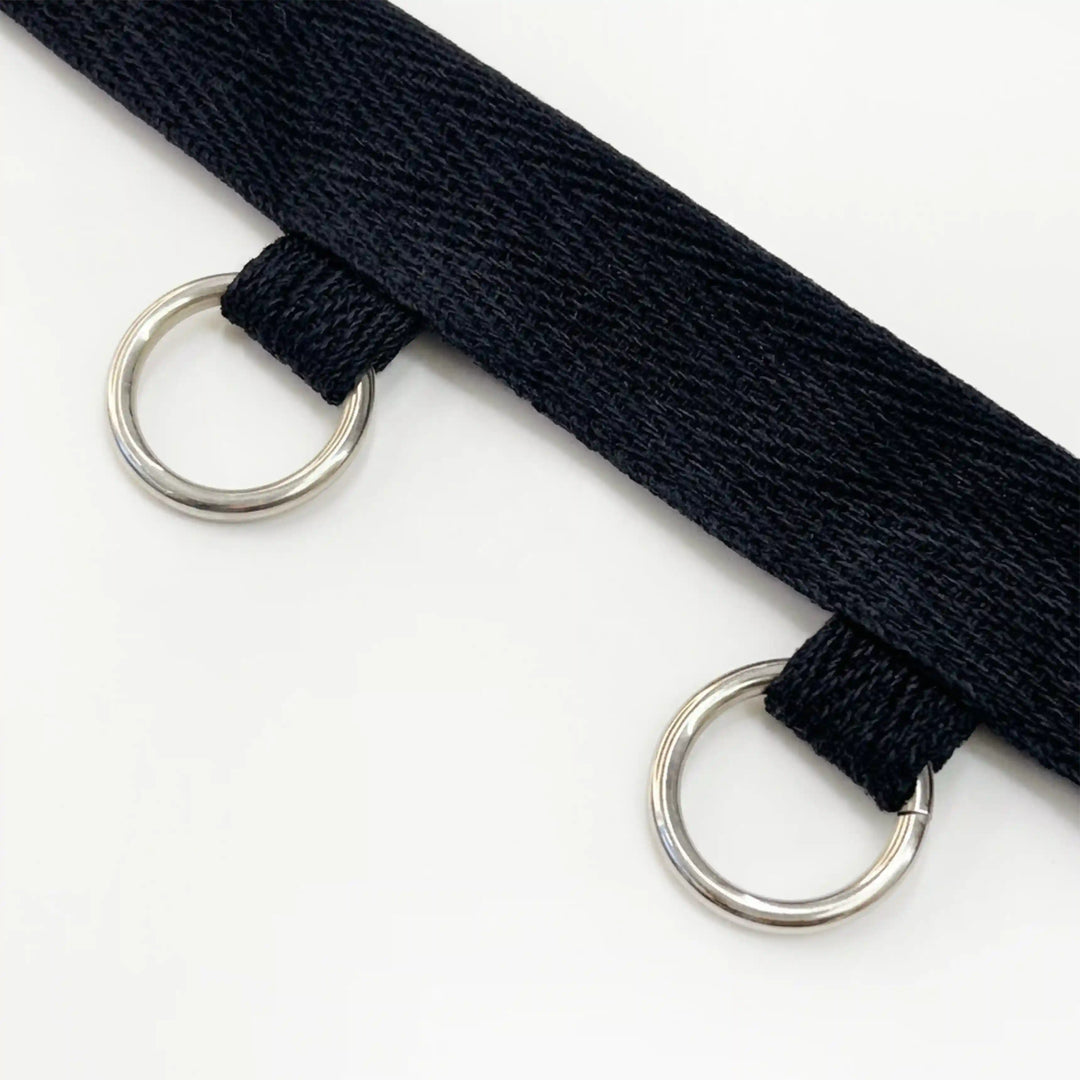 ANI Accessories close-up of silver O-rings hanging from black twill tape with white color background 