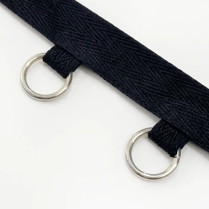 ANI Accessories close-up of silver O-rings hanging from black twill tape with white color background 