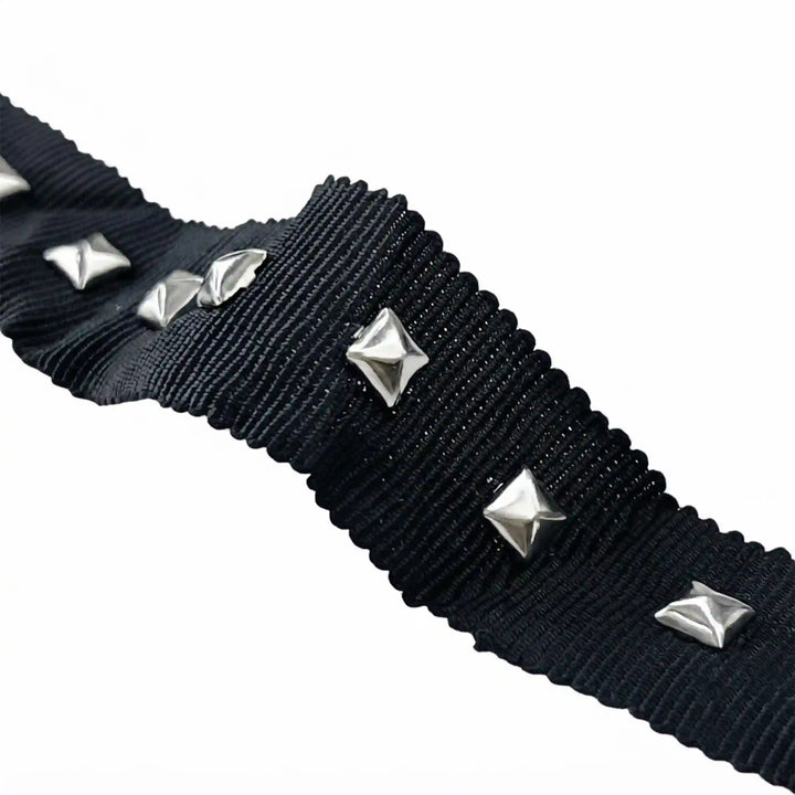 ANI Accessories close-up of silver square pyramid studs on black ribbed ribbon with white color background 