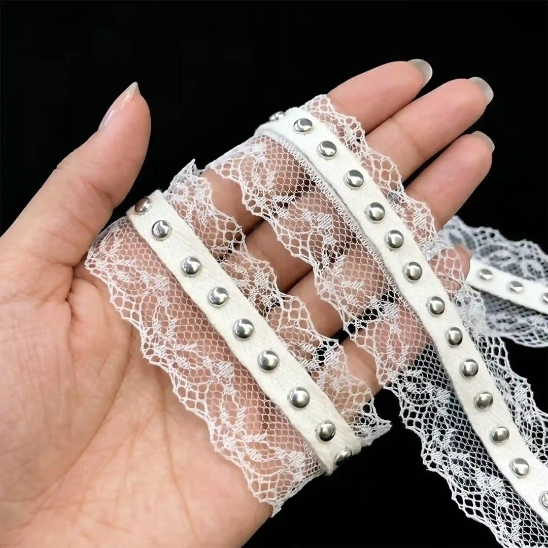 ANI Accessories silver studded lace held in hand to show the net and studs with black color background 