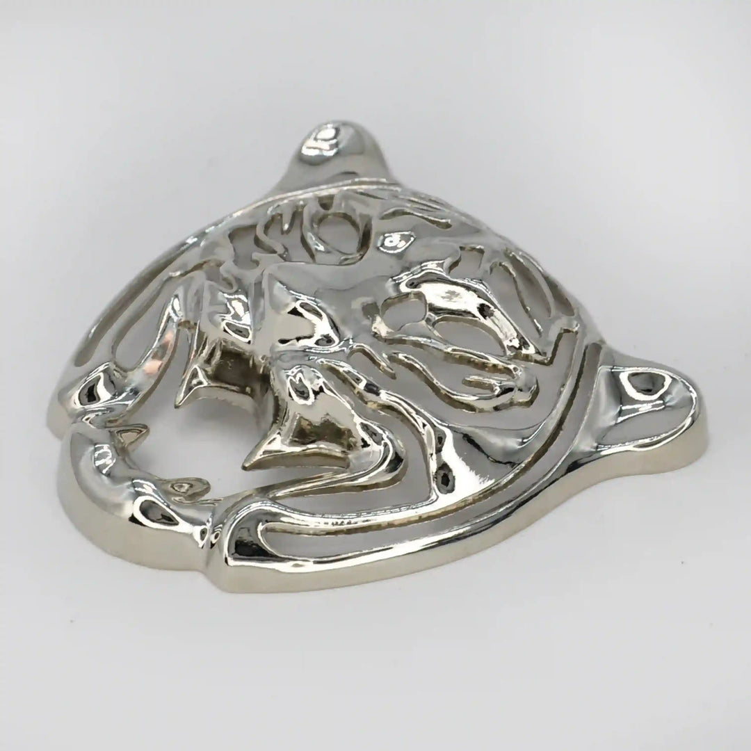Side view of the silver tiger head emblem with high-shine finish with white color background 