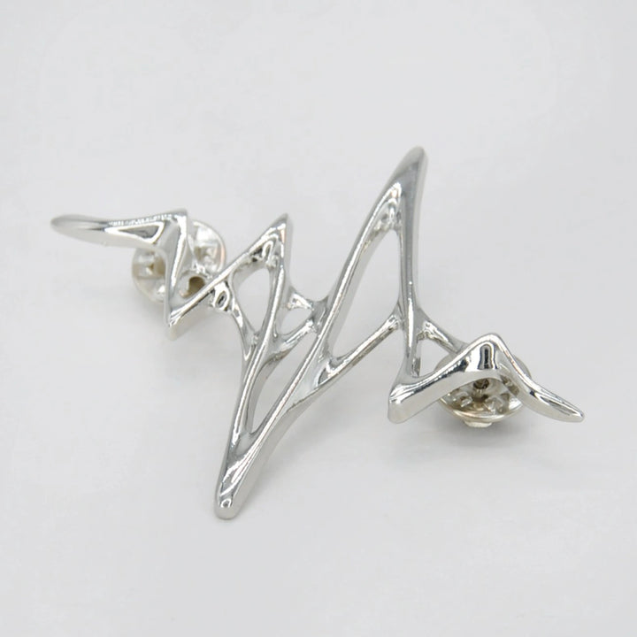 ANI Accessories silver wave lapel pin from an angle showing the raised wire design 